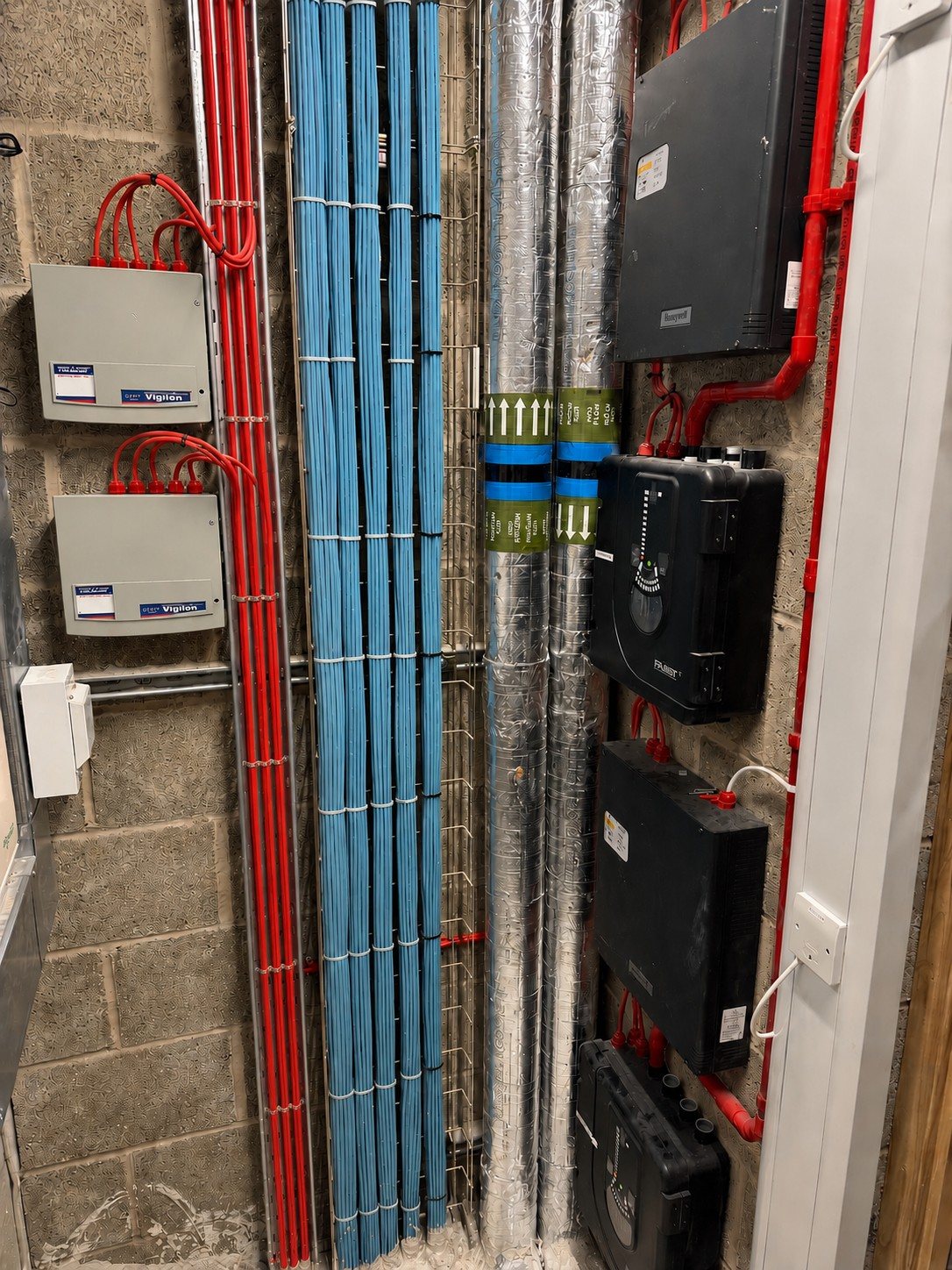 Containment and cabling installed to a fire alarm riser